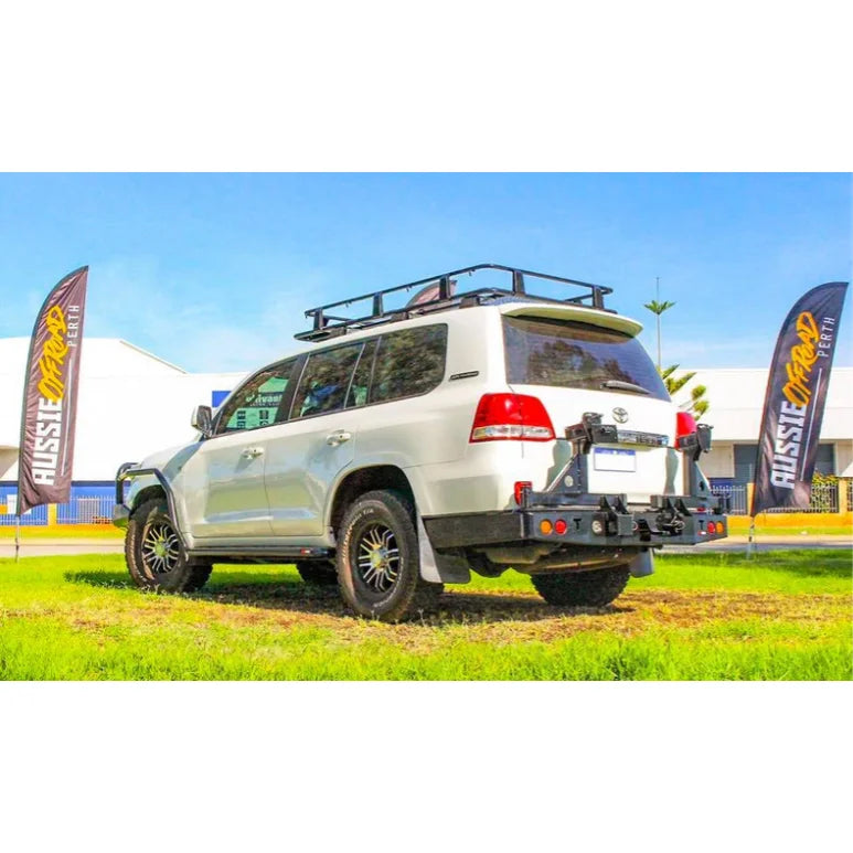 White off-road SUV with roof rack displaying Rockarmor Steel Dual Wheel Carrier for Toyota Landcruiser Fj200