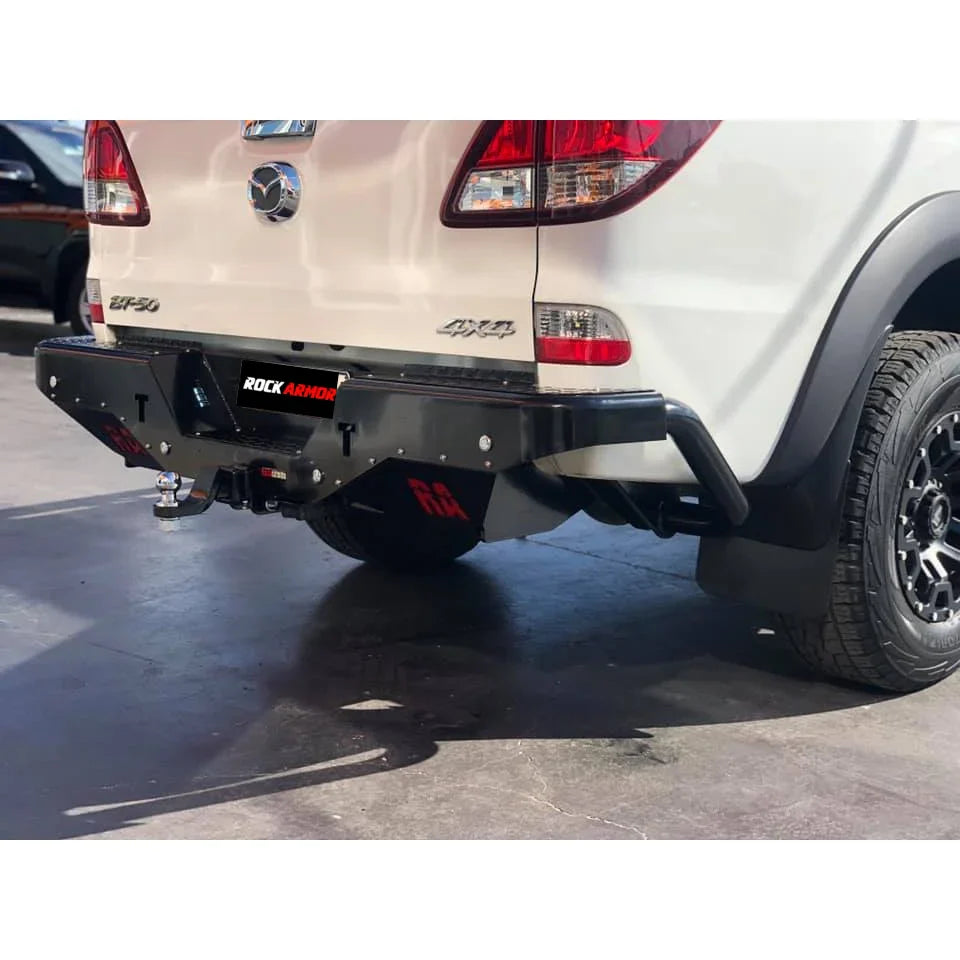 White Mazda BT-50 pickup truck with aftermarket rear step tow bar for enhanced utility