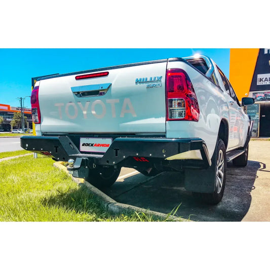 White Toyota Hilux with aftermarket rear bumper featuring rear step tow bar for N80 2015+