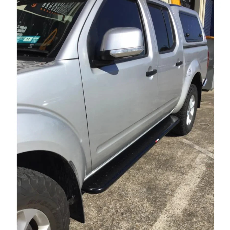 Silver Nissan Navara pickup with black brush bars and premium steel Rockarmor Brushbar