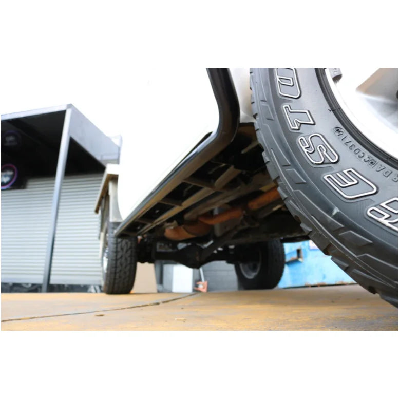 Vehicle undercarriage with tires showcasing Rockarmor Brushbar for Toyota Hilux in premium steel