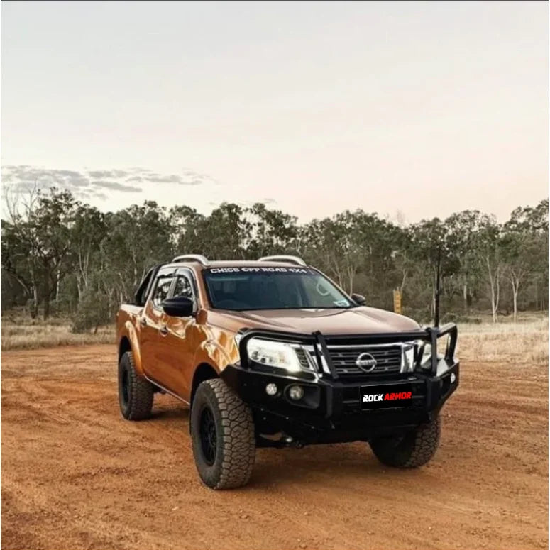 Orange Nissan pickup truck with off-road modifications showcasing Rockarmor Elite Steel Bullbar