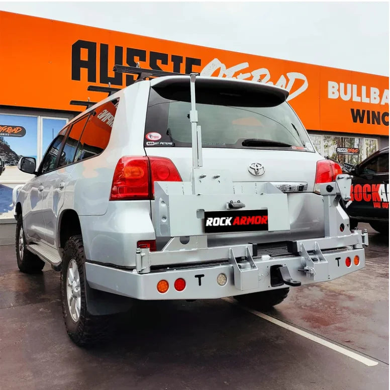 Silver SUV with aftermarket rear bar and wheel carrier for spare wheel on Toyota Landcruiser