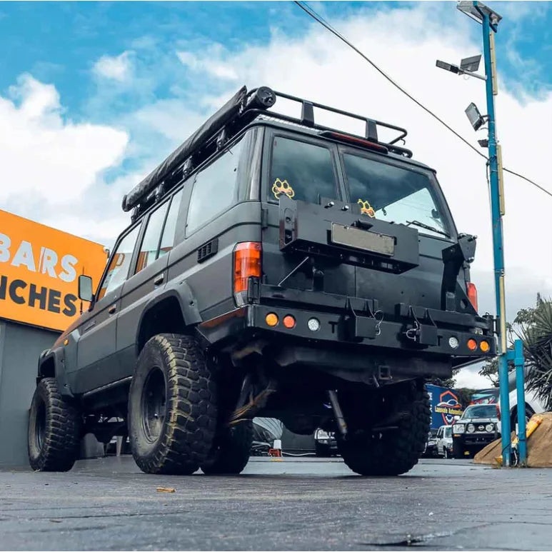 Modified black off-road vehicle with Rockarmor dual wheel carrier for Toyota Landcruiser FJ75 FJ76 FJ78